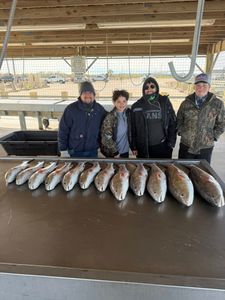 Successful redfish fishing trip in Matagorda TX with large catch displayed at cleaning station