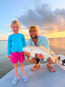 Redfish catch on boat during sunset fishing trip in Matagorda TX
