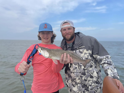 Two anglers holding a 19-inch fish in Matagorda