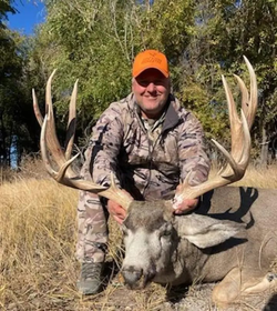 A lone hunter crouching in the Colorado wilderness