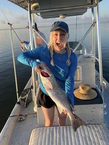 Angler with a fishing rod catches a fish in TX