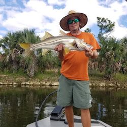 A lone fisherman basks in the glory of a bountiful catch.