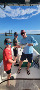 Reeling in a huge Snook under partly cloudy skies in Bonita Springs!