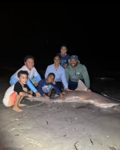 Angler holding a large Atlantic Sharpnose Shark in Destin