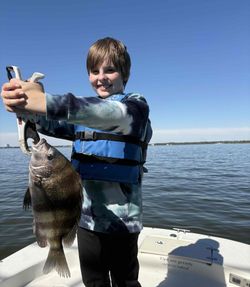 Proud black drum catch on this inshore fishing trip