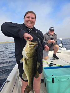 Proud largemouth bass catch on a calm lake day
