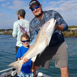 Anglers reeling in a big fish in MS