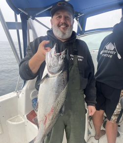 Angler holding a beautiful rainbow trout in Sooke