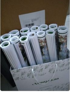 Rolled fishing charts and maps stored in cardboard box for fishing trip organization