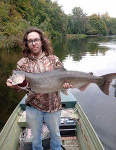 Angler with a large rainbow trout in Newaygo County