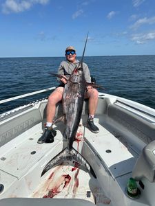 A lone angler reeling in a 57-inch fish in Gulfport