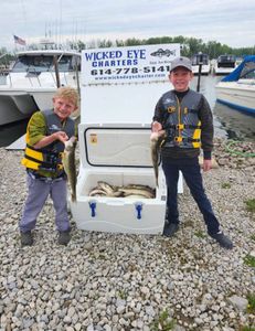 Two people fishing in Marblehead with a 14-inch catch