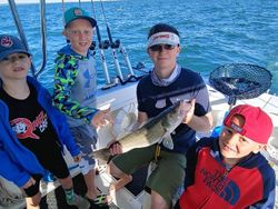 Four friends enjoying a great day of fishing in Marblehead