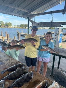Three redfish being caught during a fishing trip in LA