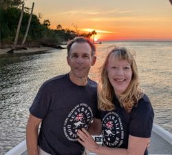 Two people enjoying fishing, hunting, and tours in FL