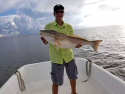 A lone fisherman in LA reeling in a catch
