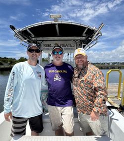 Three people enjoying a day of fishing in Cape Carteret
