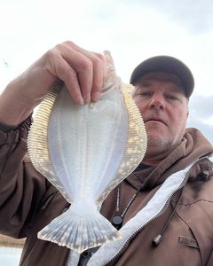 Fisherman catching a 15-inch fish in Cape Carteret