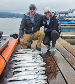 Two people fishing on the docks in Astoria