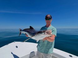 A fisherman holds a large lake sturgeon caught in VA.