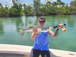 A fisherman catches a snook in Florida