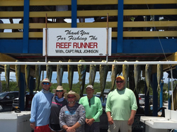 Anglers fishing in Islamorada, catching a 19-inch fish