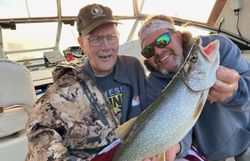 Angler with a large lake trout caught while fishing in Minnesota
