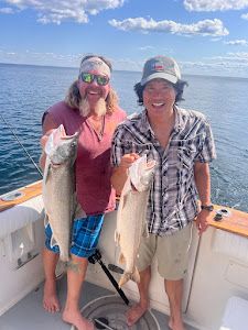 Two anglers reeling in big fish in Knife River
