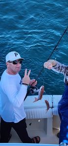 Fishing from boat showing caught fish on fishing line in Gulf Shores AL waters