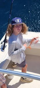 Angler holding caught fish on fishing boat in Gulf Shores AL