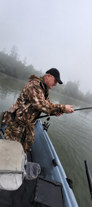 Angler fishing from boat on misty water near Centralia WA