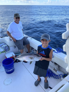 Smiling angler with a big greater amberjack fish in AL