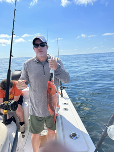 Two people fishing on the shores of Dauphin Island