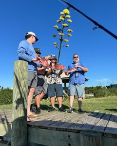 Four people fishing at Dauphin Island
