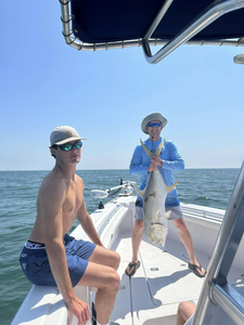 Joyful anglers with a giant Jack Crevalle catch!