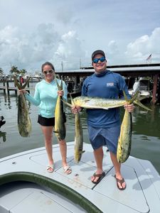 Three people fishing with rods in FL