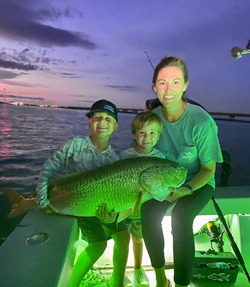 Three anglers with a catch of one fish in Manns Harbor
