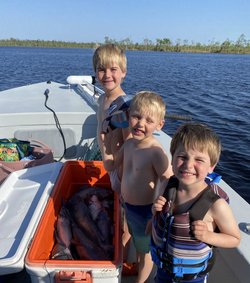 Kids with big catfish catch.