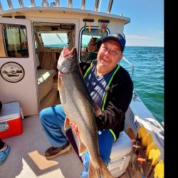 Angler with a large lake trout fish caught in Henderson