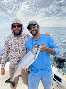 A pair of anglers catching a lake trout in Henderson