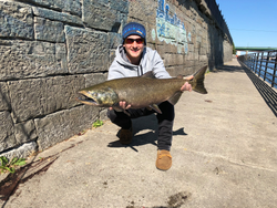 A person fishing for a lake trout in NY