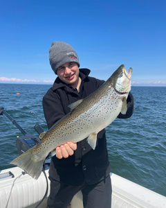 Angler holding a rainbow trout fish in NY
