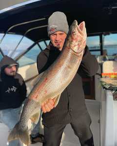 Angler reeling in a rainbow trout in NY