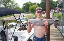 A fisherman holding a blue catfish in Wagoner
