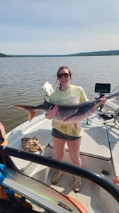 A fisherman holds a large fish in OK