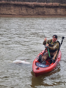A fisherman holding a 25-inch fish in Wagoner