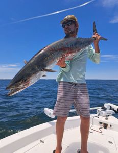 A fisherman holding a large wahoo fish in Florida