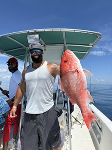 Huge 45-inch Red Snapper reeled in during deep sea adventure!
