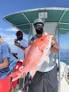 Deep sea adventure yields a prized Red Snapper under clear skies!