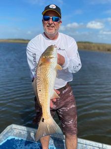 Fisherman reeling in a fish on a sunny day in Florida